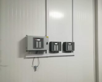 Three Fancom climate controllers mounted on the wall