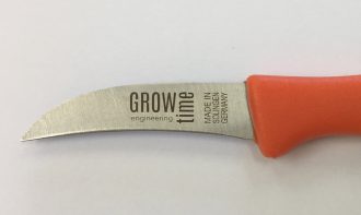 Close-up on the blade of a mushroom knife lying free